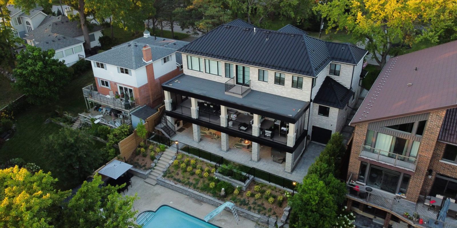Aerial view of luxury custom home with pool